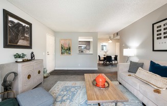 a living room with couches and chairs and a floor lamp