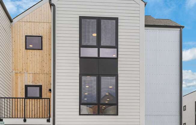 A modern house with a balcony and a garage door.