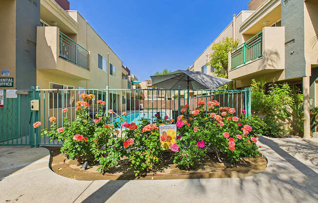 A flower bed in front of a building with a sign that says "Entertainment".