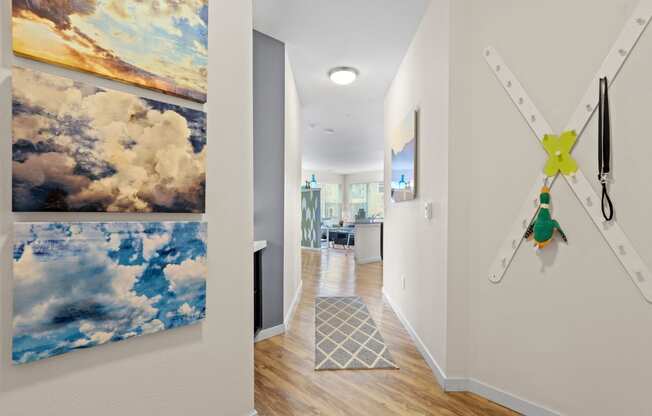 a hallway with paintings and a clock on the wall