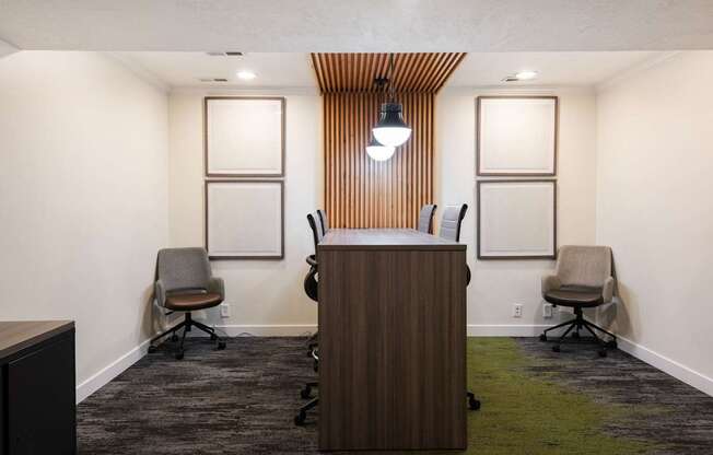a conference room with a wooden desk and chairs