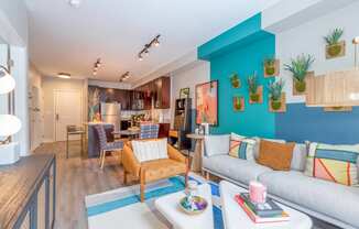 a living room with a blue accent wall and a gray couch