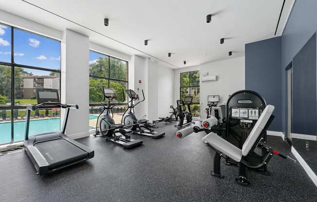 A spacious home gym with a treadmill, exercise bike, and other equipment.