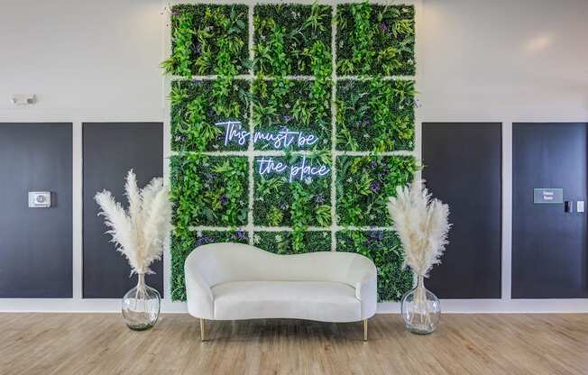 a living wall with a white couch in front of it