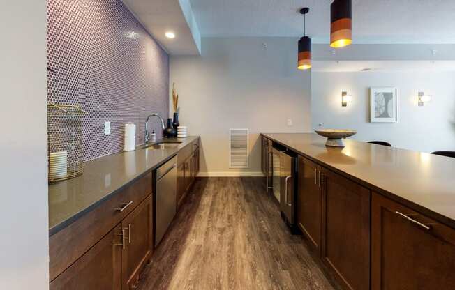 a kitchen with a long counter and wooden cabinets