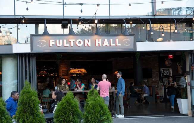 people standing outside of a restaurant with a sign at The Paxton, Brooklyn, NY