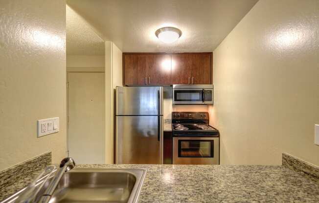 Kitchen with Granite Countertops, Refrigerator and Ceiling Light