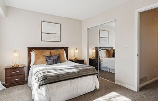 a bedroom with a bed and a mirror