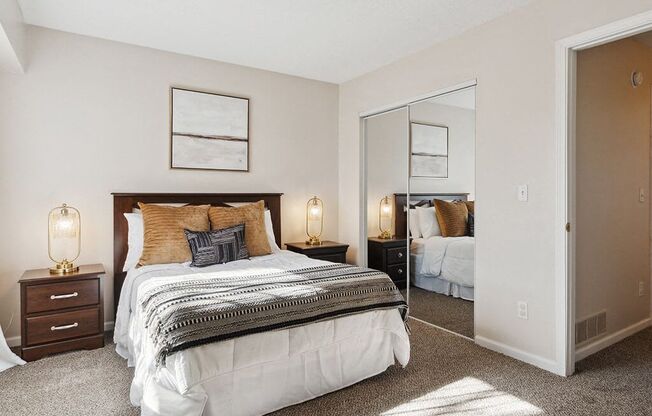 a bedroom with a bed and a mirror