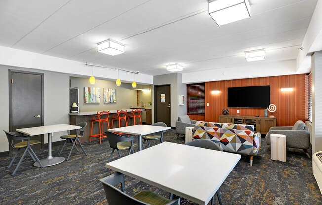 A room with a white table and chairs.