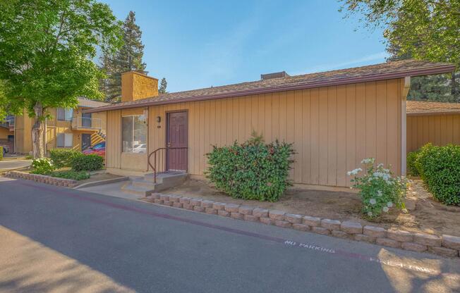 a house that has a sign on the side of a road