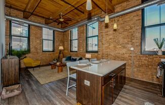 Open living area with a ceiling fan and lovely city views at Carriage House Lofts, Chicago