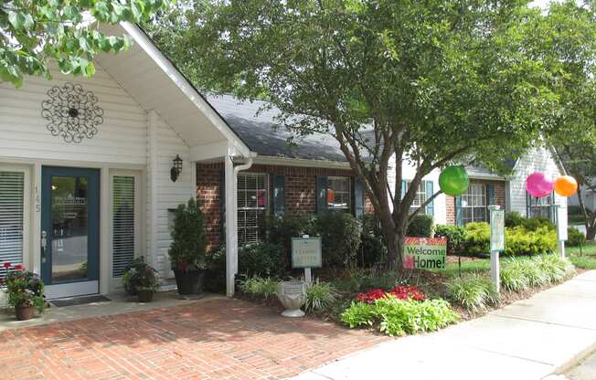 A white house with a sign that says Welcome Home.