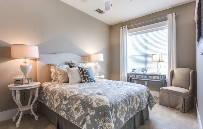 View of Bedroom, Showing Bedding and View of Window at Alpha Mill Apartments