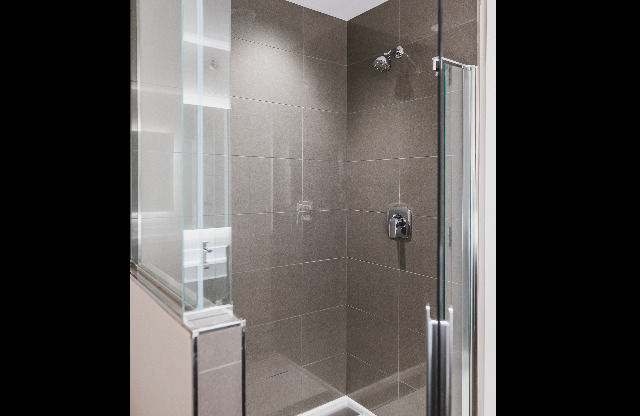 Serene bathrooms with spa-like glass showers with tile surround