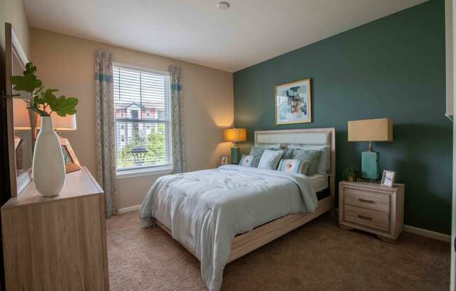 a bedroom with a bed and a window