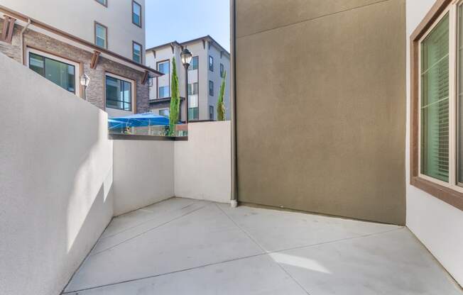 a patio with a wall and a door to a balcony at Metro Gateway, Riverside, CA, 92503