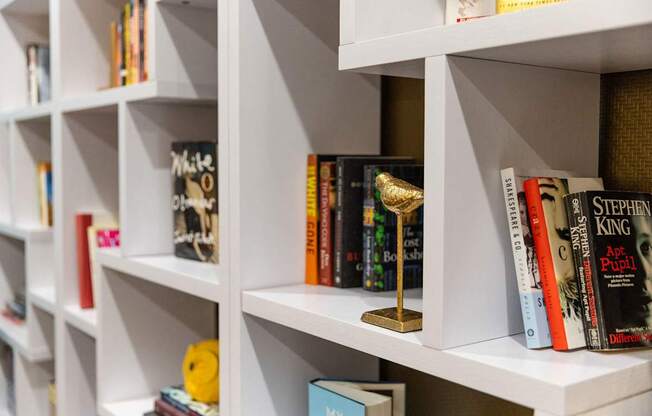 a bookshelf filled with books and a gold trophy