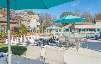 a pool with a bunch of chairs and umbrellas