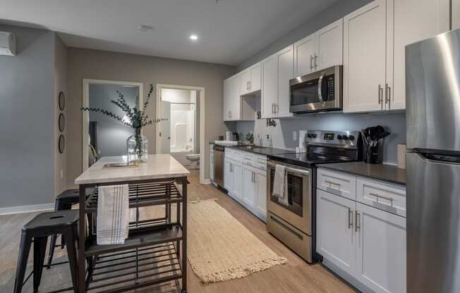 a kitchen with stainless steel appliances and a wooden table