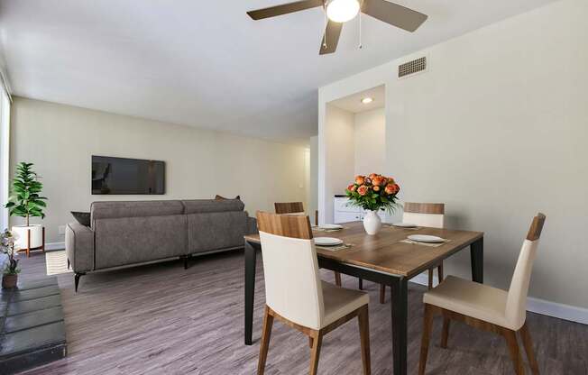 a living room and dining room with a table and chairs