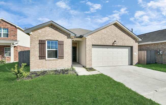 A two-story house with a garage and a driveway.