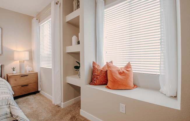 Bedroom window seat and built in shelving with plenty of natural light from two windows