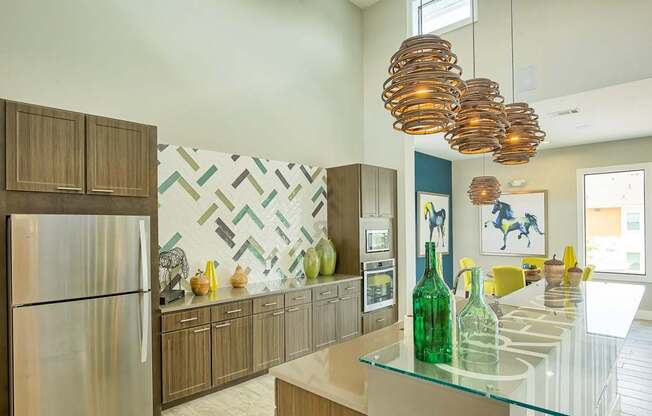 A modern kitchen with a glass counter top and wooden cabinets.