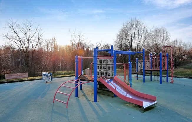 a playground with a slide and other equipment in a park