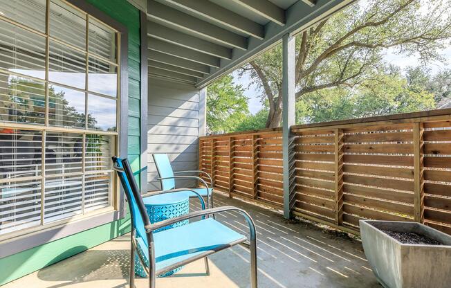 furnished patio with blue chairs