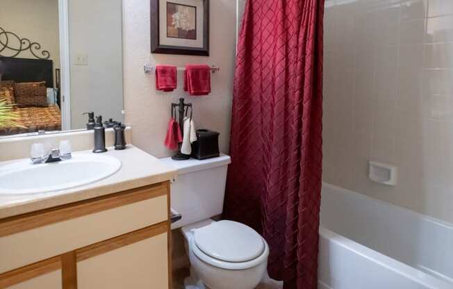 an image of a bathroom with a toilet sink and tub at The Summit Apartments, Memphis, 38128