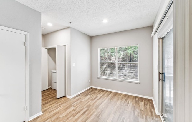a room with pink and white walls and a wooden floor