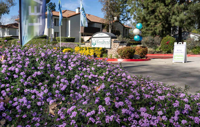 A sign for Woodend is in front of a building.
