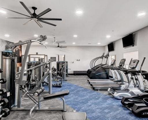 A well-equipped gym with a variety of machines and weights.