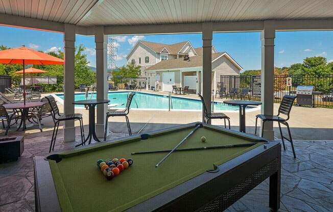 a pool table with a view of a swimming pool