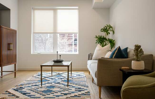a living room with a couch and a coffee table at The Lucy Boise Apartments, Boise, Idaho