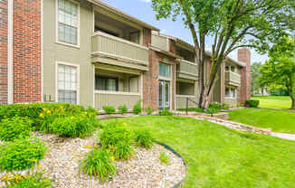 A building with a green lawn in front.