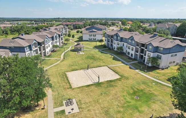 an aerial view of a group of houses in a field