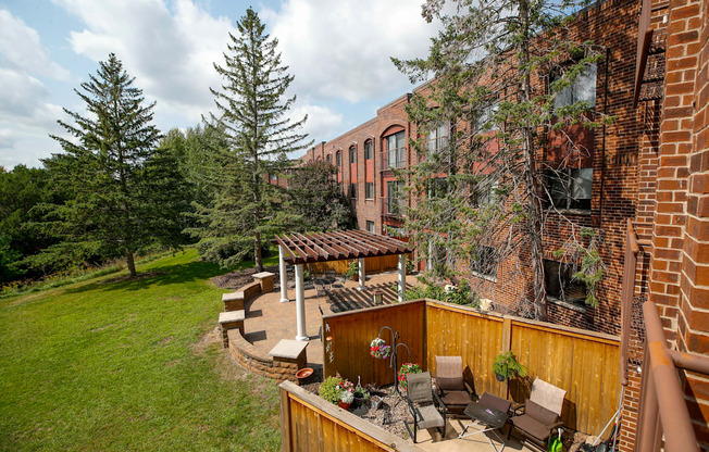 a backyard with a patio and a brick building