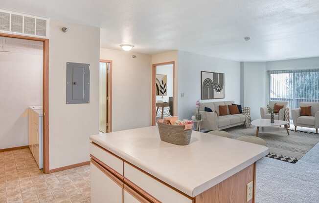 an open living room and kitchen with a living room with a couch