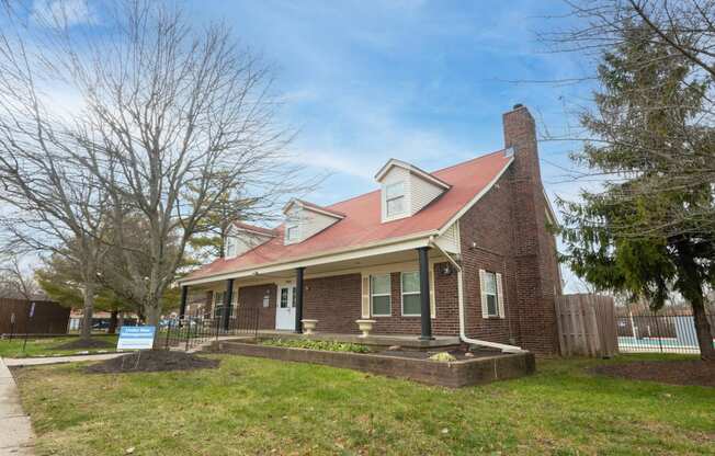 an old brick house with a red roof