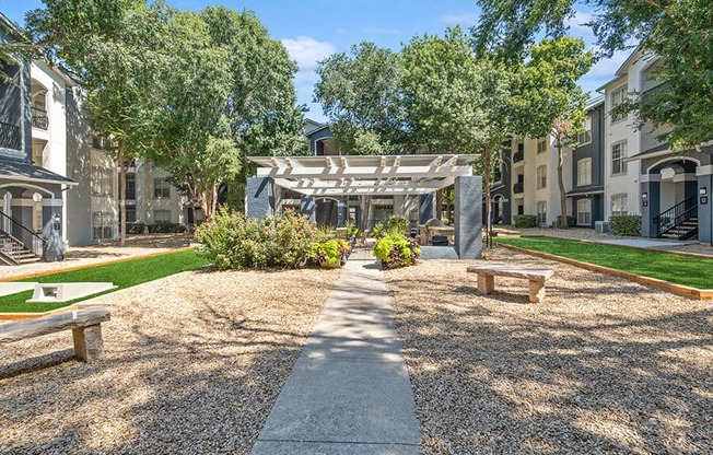 Community Courtyard with Benches at Allure North Dallas Apartments in Dallas, TX.
