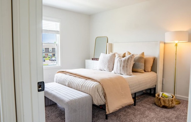 a bedroom with a bed and a chair in a 555 waverly unit