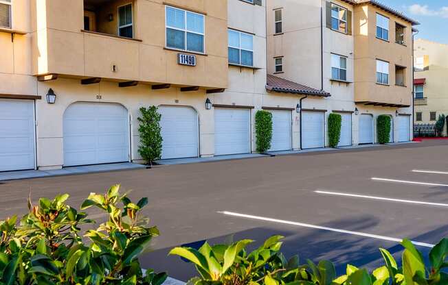 an empty parking lot in front of an apartment building