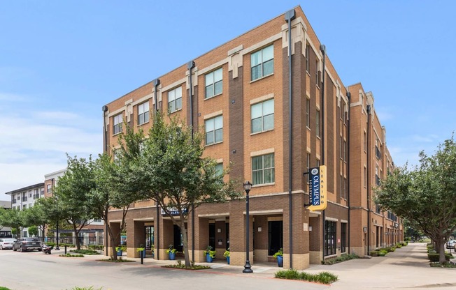 A large brick building with a yellow sign on the front.