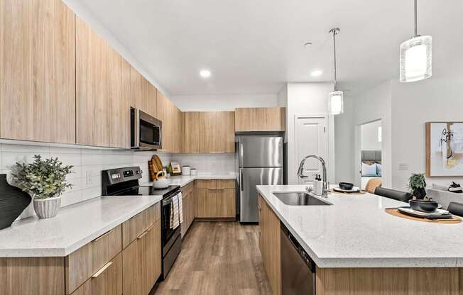 A modern kitchen with wooden cabinets and stainless steel appliances.