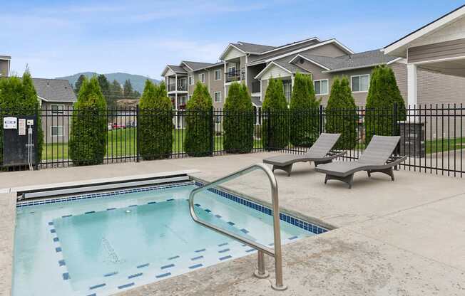 A swimming pool with a metal ladder in the middle of it.