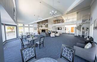 A living room with a grey couch and a fireplace.
