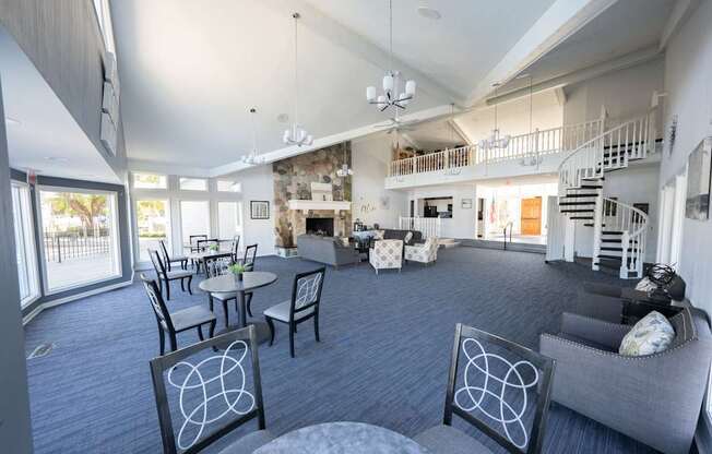 A living room with a grey couch and a fireplace.