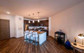 an open kitchen and dining room with a bar and stools